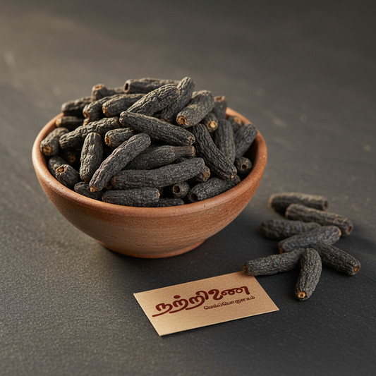 Nattrinai Maratti Mokku dark cylindrical marking nut pieces in a ceramic bowl on dark slate surface with brand tag placed flat beside it