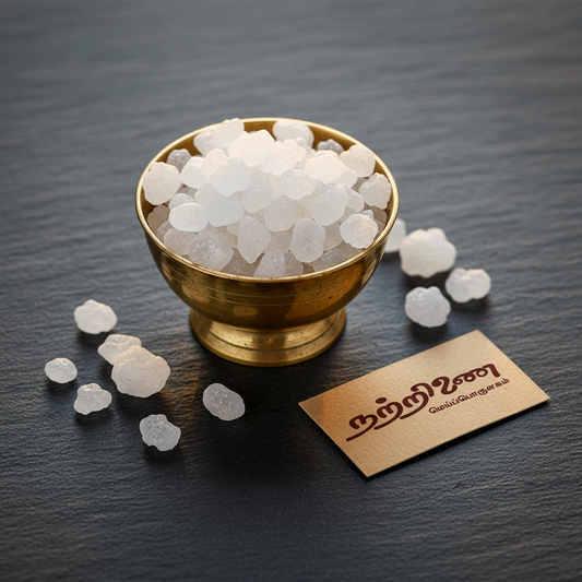 Nattrinai Pachakarpooram edible camphor crystals in a brass bowl on dark slate surface with brand tag placed flat beside it